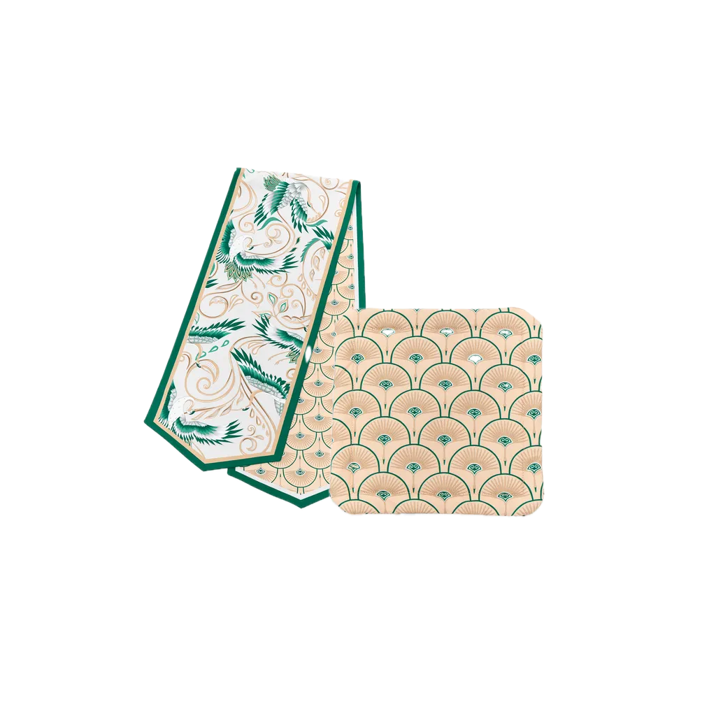 A beige and green tablecloth set with ornaments.